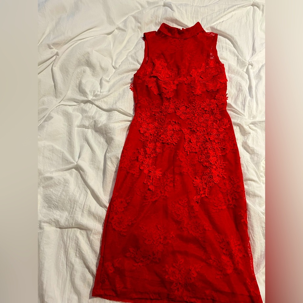 Red sheer high collar sleeveless cocktail dress with lace appliqué. FashionNova
